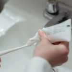 Person holding hand and toothbrush